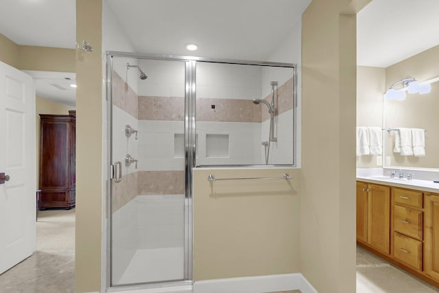 bathroom with vanity and a shower with shower door