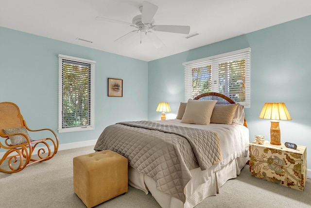 carpeted bedroom featuring ceiling fan and multiple windows