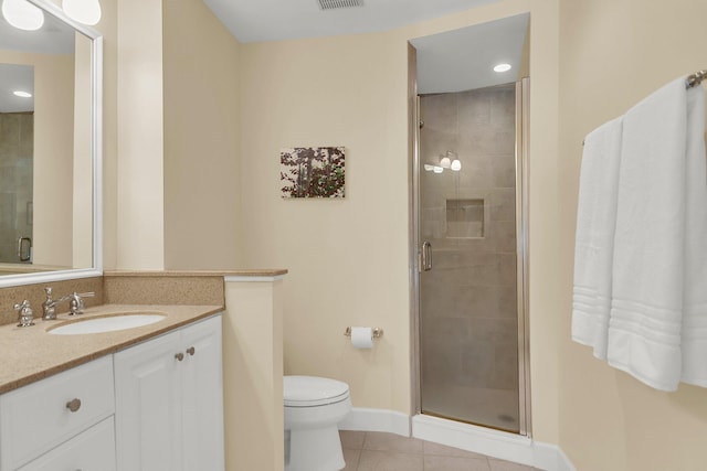 bathroom with tile patterned floors, vanity, toilet, and a shower with shower door