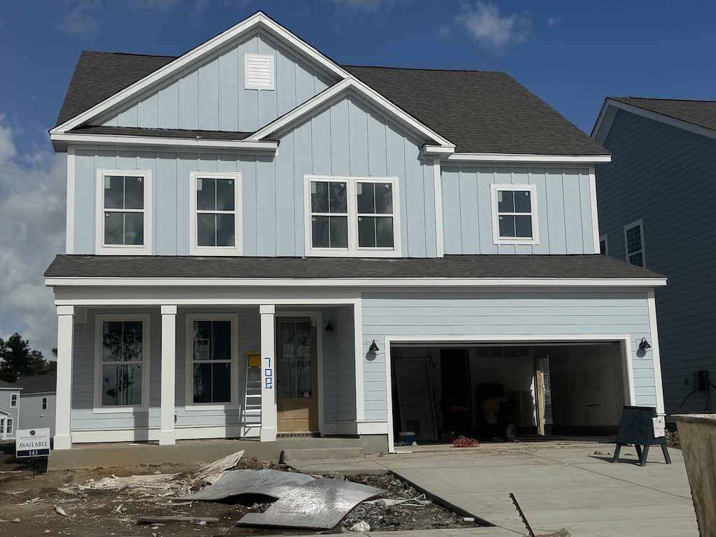 view of front facade featuring a garage and covered porch