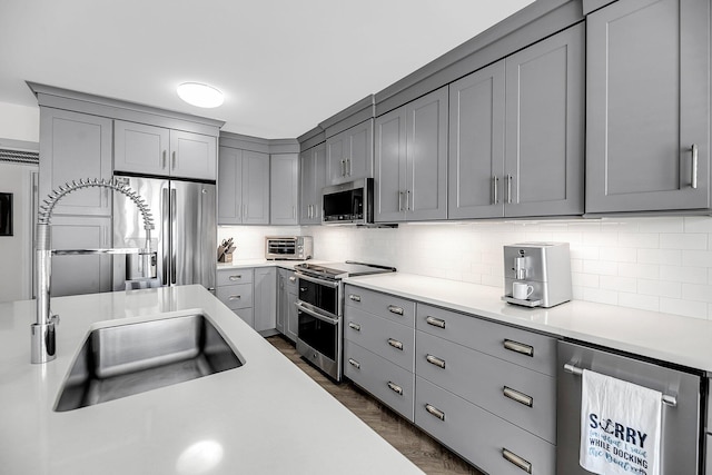 1948 Marsh Oak Ln, Seabrook Island, SC 29455 - kitchen featuring appliances with stainless steel finishes, gray cabinetry, a sink, light countertops, and backsplash