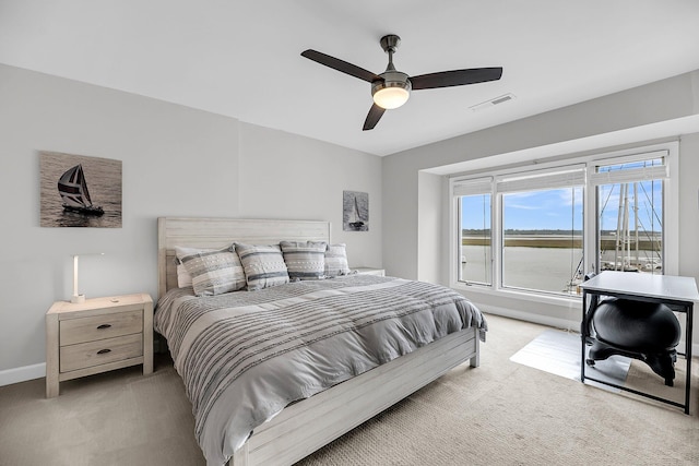 1948 Marsh Oak Ln, Seabrook Island, SC 29455 - bedroom featuring light colored carpet, baseboards, ceiling fan, and a water view