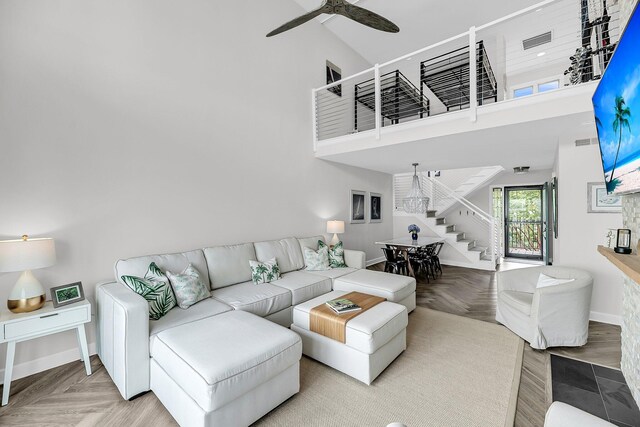 1948 Marsh Oak Ln, Seabrook Island, SC 29455 - living area with stairway, a high ceiling, baseboards, and a ceiling fan