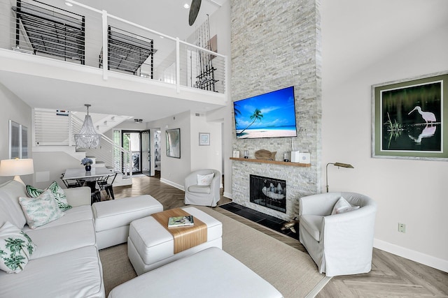 1948 Marsh Oak Ln, Seabrook Island, SC 29455 - living area with baseboards, a chandelier, a stone fireplace, and a high ceiling