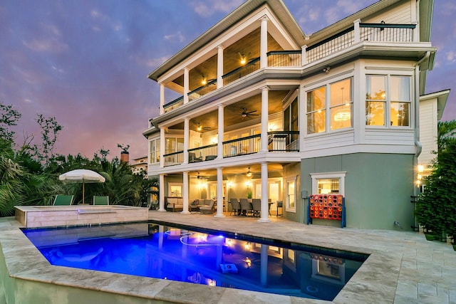 1720 Bowline Dr, Mount Pleasant, SC 29466 - back of property at dusk featuring a balcony, a ceiling fan, an in-ground hot tub, a patio, and an outdoor hangout area