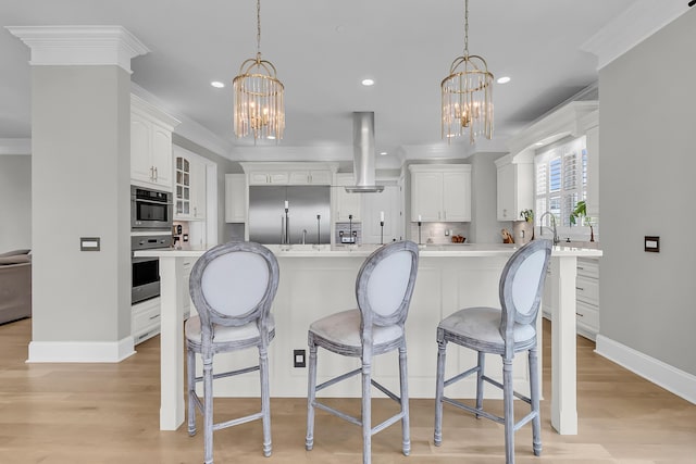 1720 Bowline Dr, Mount Pleasant, SC 29466 - kitchen with a chandelier, stainless steel built in fridge, island exhaust hood, white cabinets, and recessed lighting