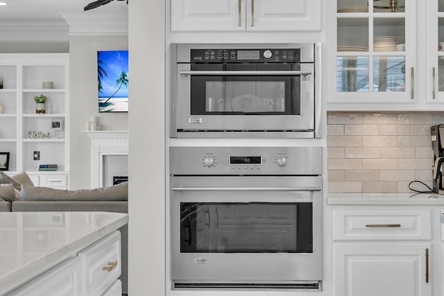 1720 Bowline Dr, Mount Pleasant, SC 29466 - kitchen with crown molding, white cabinets, decorative backsplash, and glass insert cabinets