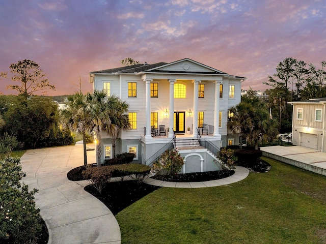 1720 Bowline Dr, Mount Pleasant, SC 29466 - neoclassical home featuring stairs, covered porch, a front lawn, and concrete driveway