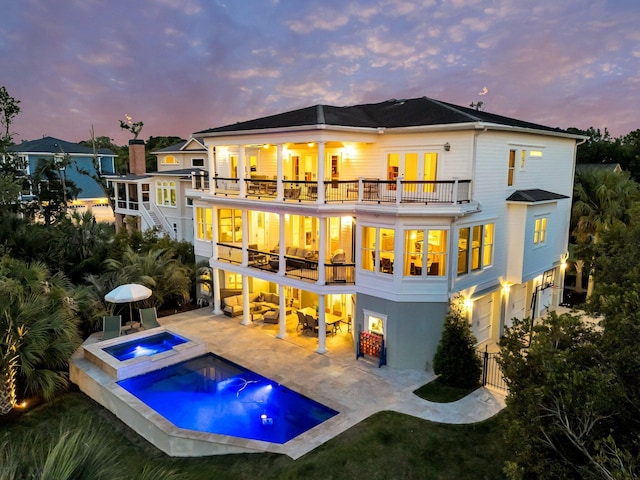 1720 Bowline Dr, Mount Pleasant, SC 29466 - back of property featuring a balcony, a patio, a pool with connected hot tub, and stairs
