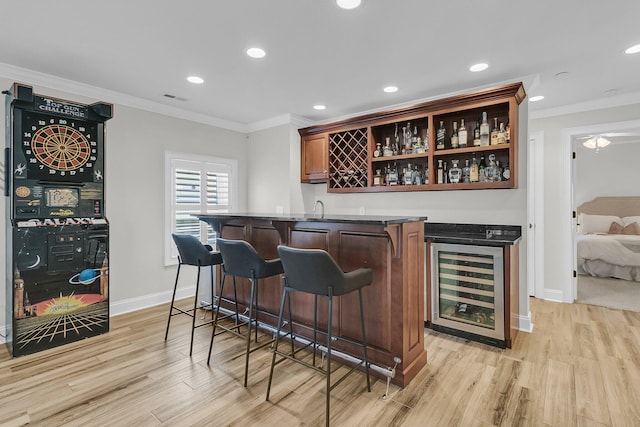 1720 Bowline Dr, Mount Pleasant, SC 29466 - indoor wet bar with beverage cooler, crown molding, light wood finished floors, baseboards, and recessed lighting
