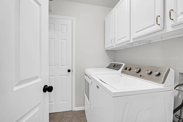 laundry area featuring cabinets and washing machine and dryer