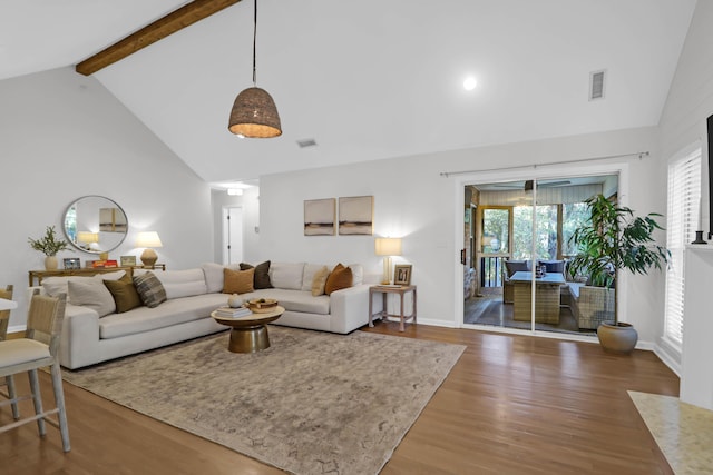 living room featuring high vaulted ceiling, hardwood / wood-style flooring, and beam ceiling