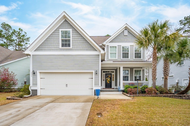 view of front facade featuring a garage, concrete driveway, a porch, and a front yard