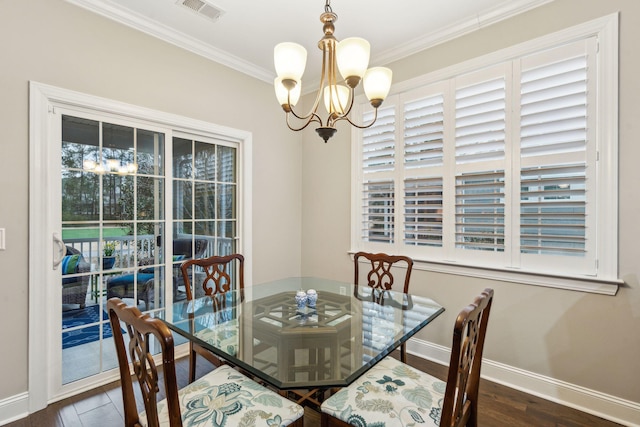 dining room featuring visible vents, a notable chandelier, dark wood finished floors, crown molding, and baseboards