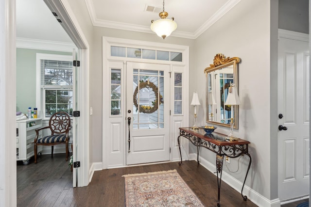 foyer with visible vents, baseboards, dark wood-type flooring, and crown molding