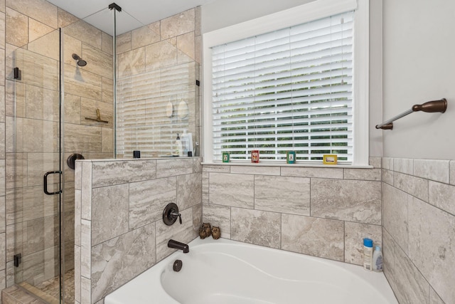 full bathroom featuring a tub to relax in and a stall shower