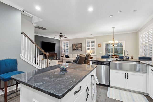 kitchen with dishwasher, crown molding, visible vents, and a sink