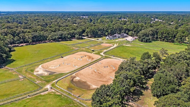 birds eye view of property featuring a rural view and a wooded view