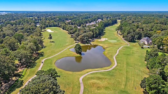 aerial view featuring a wooded view, a water view, and view of golf course