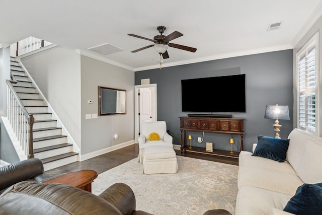 living area featuring visible vents, ornamental molding, wood finished floors, baseboards, and ceiling fan