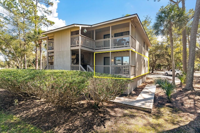 back of house featuring a balcony