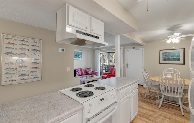 kitchen with under cabinet range hood, white cabinetry, white electric stove, light wood finished floors, and ceiling fan