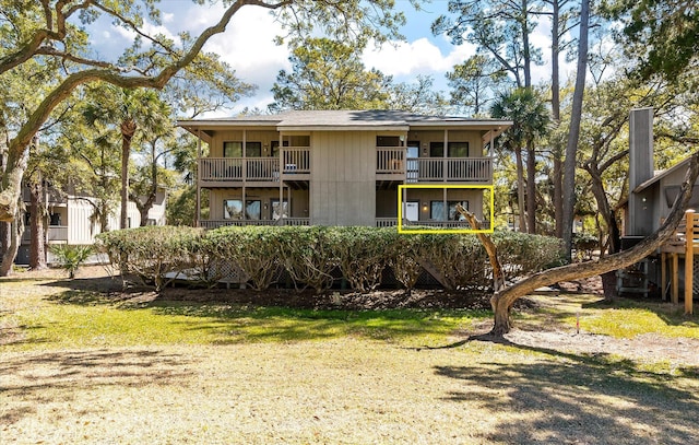 rear view of property featuring a balcony