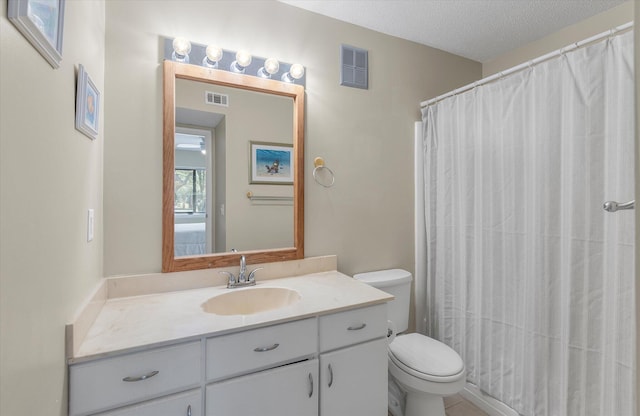 bathroom with visible vents, toilet, vanity, and a textured ceiling