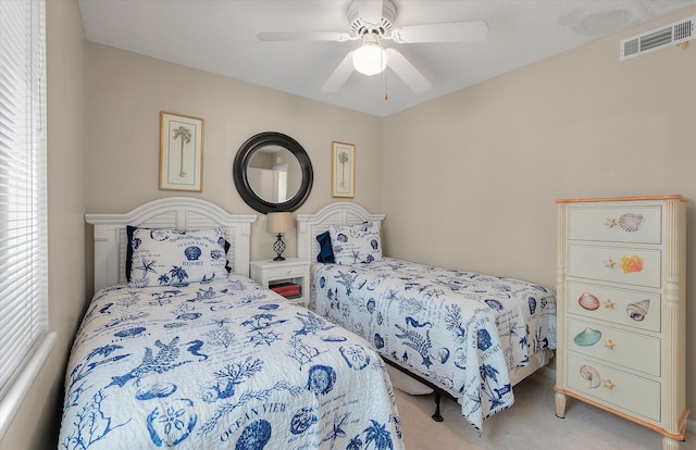 carpeted bedroom featuring visible vents and a ceiling fan