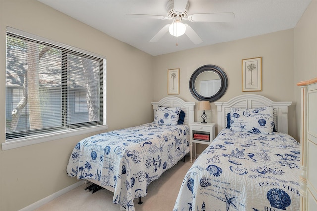 carpeted bedroom featuring ceiling fan and baseboards