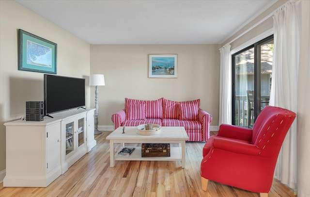 living area with light wood finished floors and baseboards