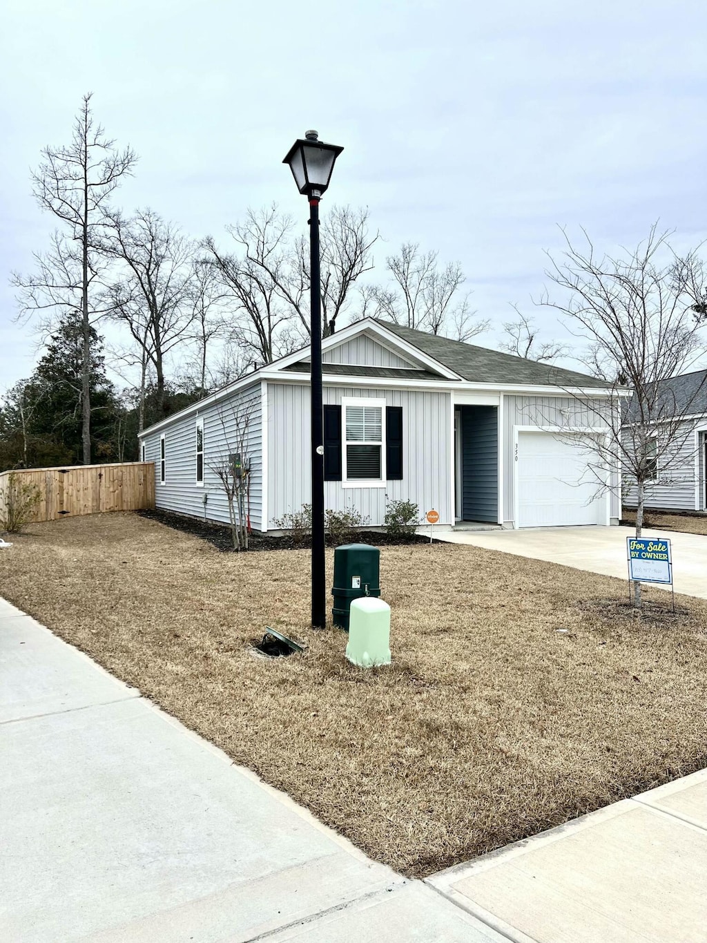 view of front of home with a front yard and a garage