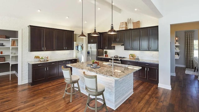 100 Fish Rd, Ridgeville, SC 29472 - kitchen featuring dark brown cabinets, stainless steel fridge, a sink, tasteful backsplash, and under cabinet range hood