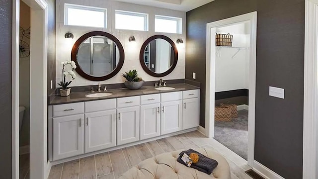 100 Fish Rd, Ridgeville, SC 29472 - bathroom featuring double vanity, a sink, wood finished floors, and visible vents