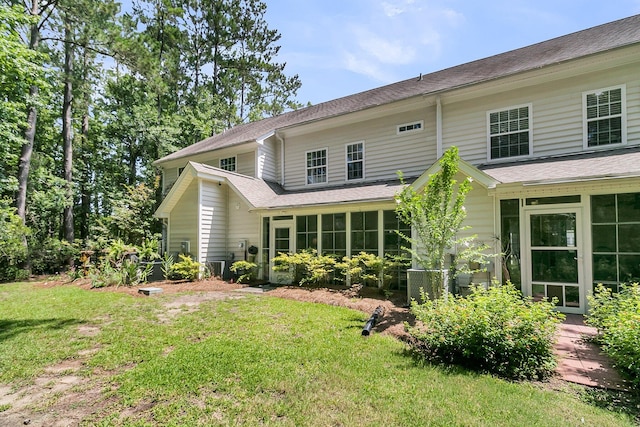 1682 Camfield Ln, Mount Pleasant, SC 29466 - back of property featuring a lawn, a sunroom, and roof with shingles