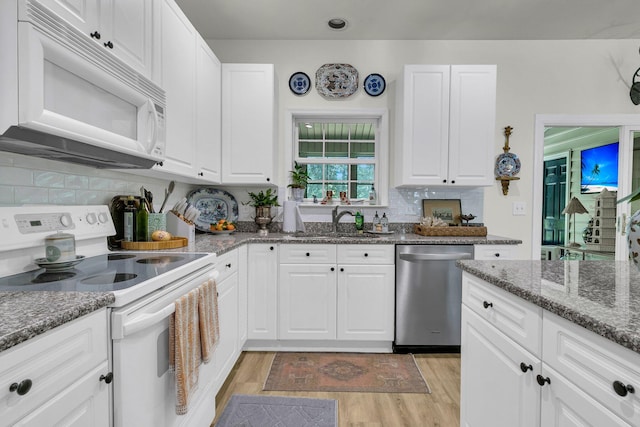 1682 Camfield Ln, Mount Pleasant, SC 29466 - kitchen with white appliances, light wood-style flooring, white cabinets, and decorative backsplash