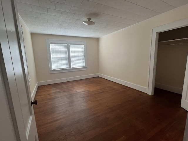 unfurnished bedroom featuring dark hardwood / wood-style flooring