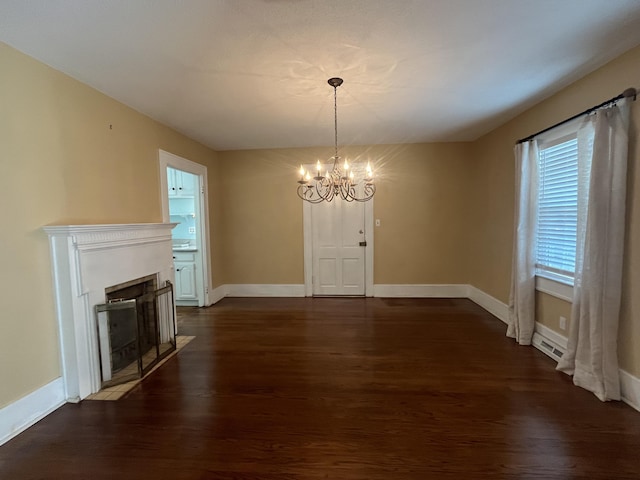 unfurnished dining area with dark hardwood / wood-style floors and a chandelier