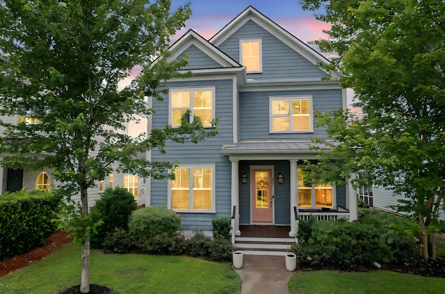 410 Eliston St, Summerville, SC 29486 - view of front of home featuring covered porch, a front yard, and a standing seam roof