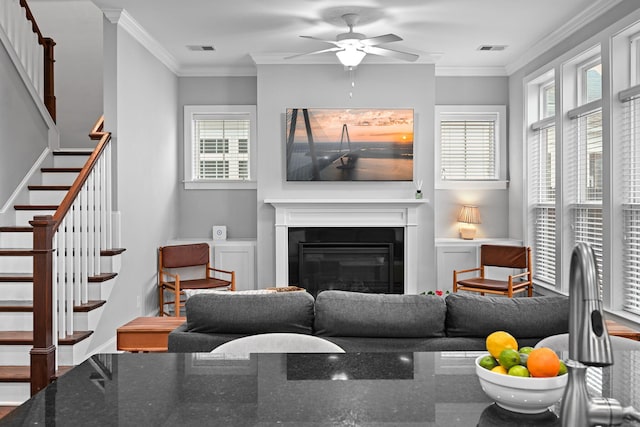 410 Eliston St, Summerville, SC 29486 - living area featuring ceiling fan, stairway, crown molding, a glass covered fireplace, and baseboards