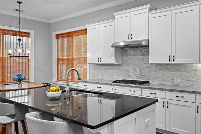 410 Eliston St, Summerville, SC 29486 - kitchen with a sink, stainless steel gas stovetop, under cabinet range hood, a chandelier, and tasteful backsplash