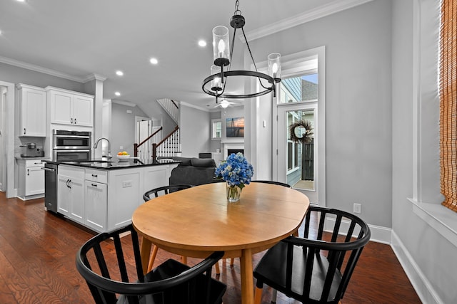 410 Eliston St, Summerville, SC 29486 - dining area featuring recessed lighting, ornamental molding, dark wood-style floors, stairway, and a chandelier