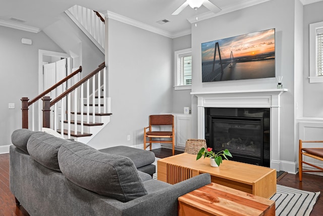 410 Eliston St, Summerville, SC 29486 - living room with ornamental molding, dark wood-type flooring, a ceiling fan, a glass covered fireplace, and stairway