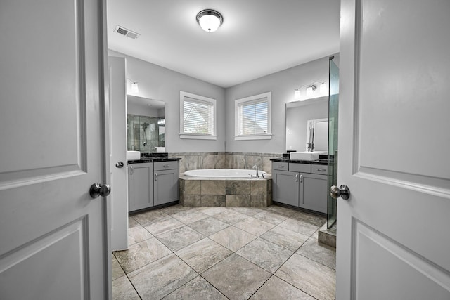 410 Eliston St, Summerville, SC 29486 - full bathroom featuring a stall shower, a bath, two vanities, and tile patterned flooring