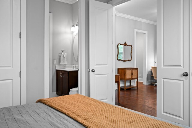 410 Eliston St, Summerville, SC 29486 - bedroom featuring crown molding, dark wood-type flooring, ensuite bath, a sink, and baseboards