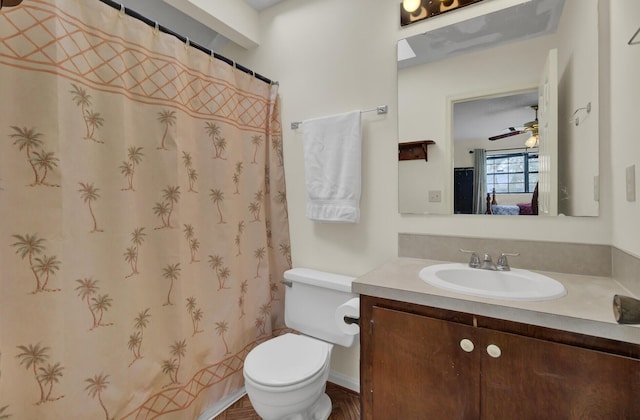 bathroom featuring vanity, ceiling fan, and toilet