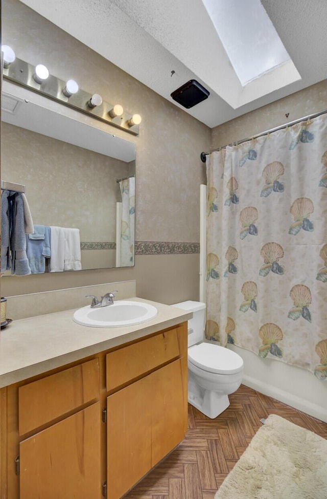 full bathroom featuring shower / tub combo with curtain, toilet, a skylight, parquet floors, and vanity