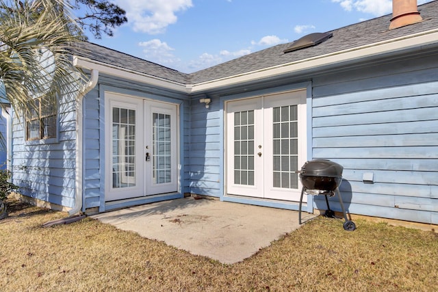 entrance to property with french doors, a yard, and a patio area