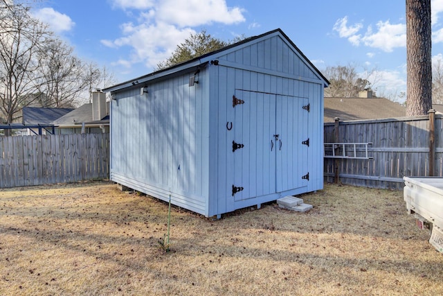 view of outbuilding with a lawn