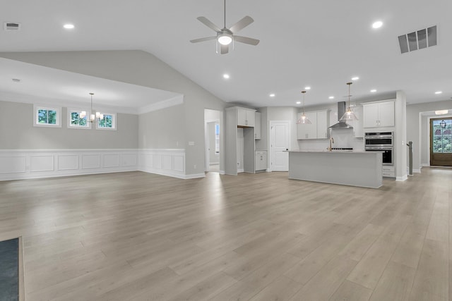 395 Wappoo Trace Ln, Summerville, SC 29486 - unfurnished living room with ceiling fan, vaulted ceiling, light wood finished floors, recessed lighting, and a sink